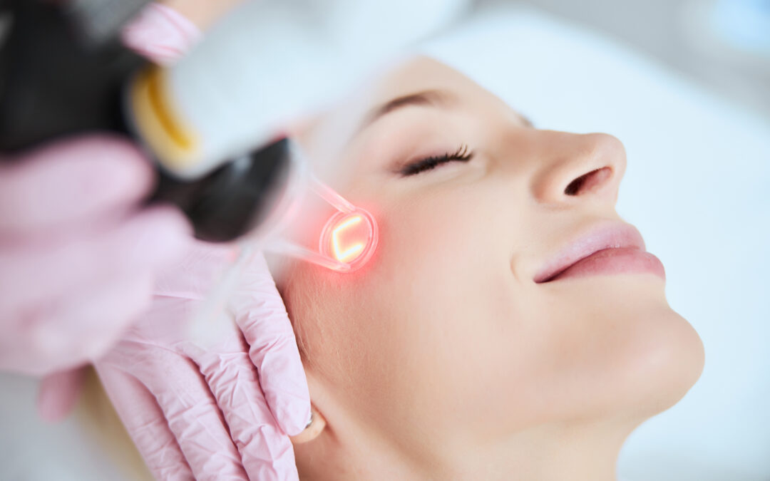 Young woman getting laser treatment on her face.