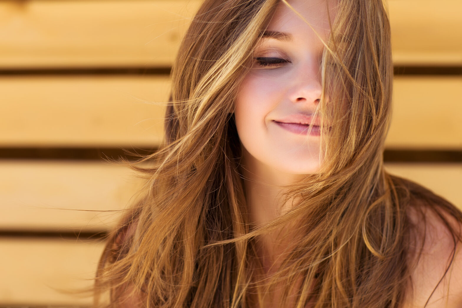 Smiling young woman with freshly restored hair and skin.